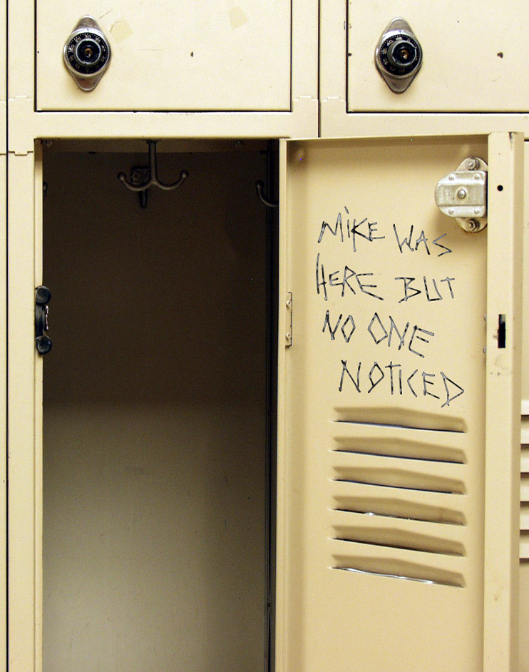Open locker with written message on door: Mike was here but no one noticed